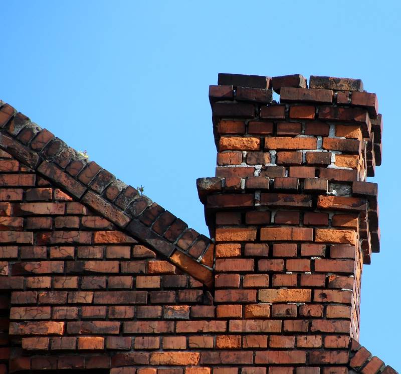 Damaged chimney on an Crest Hill home showing cracks and missing mortar